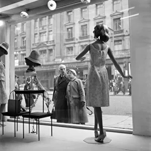 Whos the dummy? Window shopping in Oxford Street, London. 1960