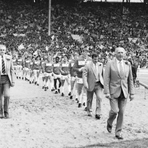 Widnes and Wigan walk out on to the pitch for the first time lead by their resceptive Widnes and Wigan walk out on to the pitch for the first time lead by their resceptive