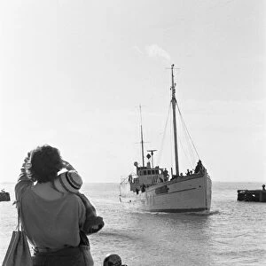 The wife and young child of one of the crew of the fishing vessel William McCann waits