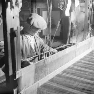 Willie Meisle using a loom to weave a tartan. Circa 1930 Willie Meisle using a loom to weave a tartan. Circa 1930