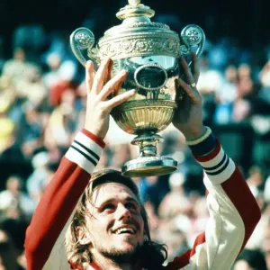 Wimbledon 1977. Bjorn Borg holds up the trophy after winning the men