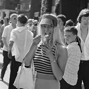 Wimbledon Tennis Championships. A tennis fan enjoys an ice cream at The Wimbledon