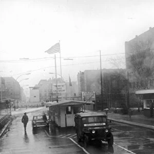A wind swept rainy day at Checkpot Charlie on Berlin Friedrich strasse