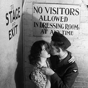 A windmill girl kisses her boyfriend, a pilot in the RAF