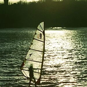 A windsurfer enjoys the sunshine despite the freezing temperatures on Edgbaston Reservoir