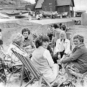 It was so windy at Whitley Bay in August, 1977, that these holidaymakers had to keep