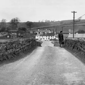 A woman crossing the bridge in Llangendeirne, Carmarthenshire Print 1964
