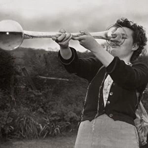 A woman drinking a yard of ale April 1952