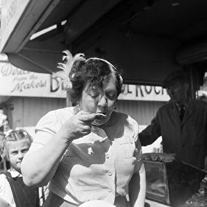 A woman eating oysters whilst on holiday in Blackpool, Lancashire. 3rd August 1953