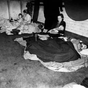 Woman feeding her baby in an underground tube station used as an air raid shelter during Woman feeding her baby in an underground tube station used as an air raid shelter during
