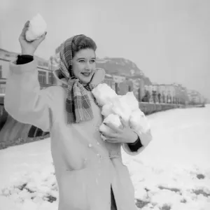 A woman having a snowball fight with her friend on Hastings beach. 8th March 1955 A woman having a snowball fight with her friend on Hastings beach. 8th March 1955