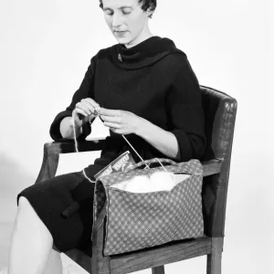 Woman knitting pose in the Daily Mirror studios Circa 1959