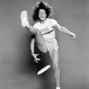A woman in motion with a frisbee, Print