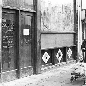 Woman pushing her baby in a pram along a Swansea street. 1st January 1965