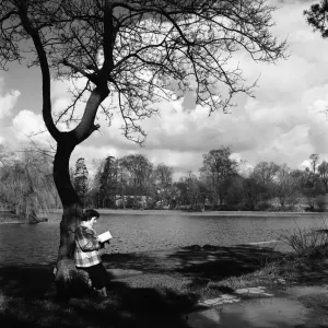Woman reading her book by the lake in the park at St. Albans. March 1952 C1266-003 Woman reading her book by the lake in the park at St. Albans. March 1952 C1266-003