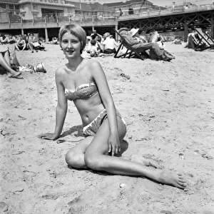 Woman relaxing on the beach at Bournemouth during a hot summer