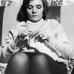 Woman seen here knitting a jumper circa 1965