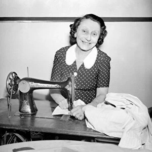 Woman with sewing machine. September 1953 D5640