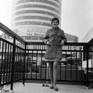 A woman stands in front of the Rotunda building