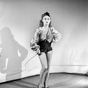 Woman wearing fancy dress jockey outfit. 1959