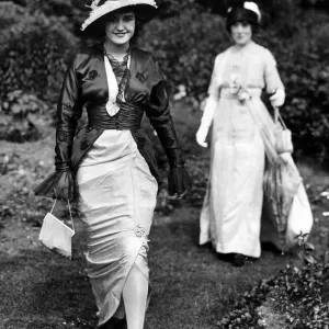 Woman wearing a slit skirt dress ans unusual hat during Royal Ascot, June 1913 Woman wearing a slit skirt dress ans unusual hat during Royal Ascot, June 1913