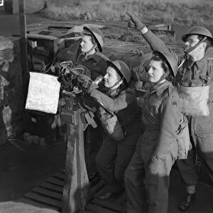 Women of the ATS operating a identification telescope at an anti aircraft battery in