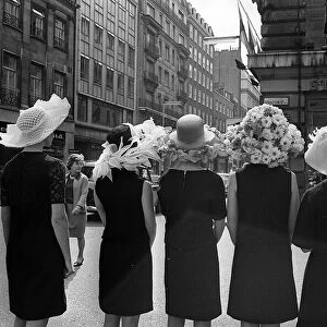 Women modelling hats for the 1966 Royal Ascot festiva - back view of the floral hatsl