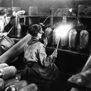 Women munition workers at munition factory, manufacturing bombs. March 1916 Women munition workers at munition factory, manufacturing bombs. March 1916