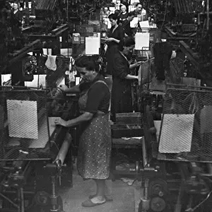 Women operating looms at a Milan mill. Circa 1955
