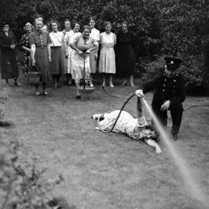 Print of Women in Royden Grove, Lincoln using a stirrup pump Print of Women in Royden Grove, Lincoln using a stirrup pump
