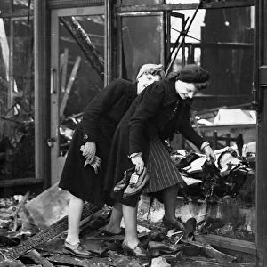 Two women salvaging the stock after their shop had been burnt out buy incendiary bombs