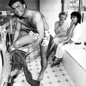 A print of a man removing jeans in a launderette A print of a man removing jeans in a launderette