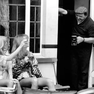 Two women stop at a pub to have a pint of beer while shopping on Kings Road in Chelsea Two women stop at a pub to have a pint of beer while shopping on Kings Road in Chelsea