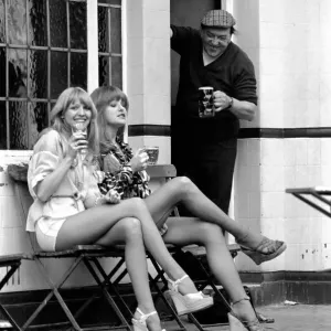 Two women stop at a pub to have a pint of beer while shopping on Kings Road in Chelsea Two women stop at a pub to have a pint of beer while shopping on Kings Road in Chelsea
