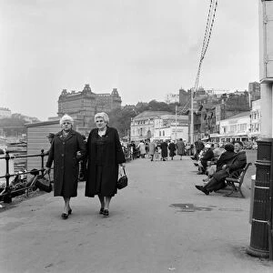 Two women taking a walk along the promenade at Scarborough, North Yorkshire. May 1964
