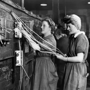 Women wiring up warship which nears completion in a Scottish Shipyard