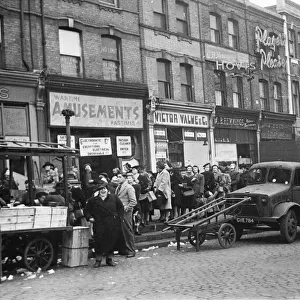 Woolwich Market, South London, and a queue for oranges and other fruit and vegetables
