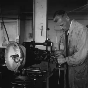 Worker assembling a gearbox in the Triumph car factory in Coventry. 23rd September 1931 Worker assembling a gearbox in the Triumph car factory in Coventry. 23rd September 1931
