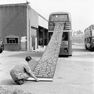 Worker at the Bus Depot winding up the destination indicator. August 1952 C4415