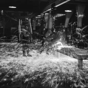 A worker casts components from molten metal at the new one million pound furnace A worker casts components from molten metal at the new one million pound furnace