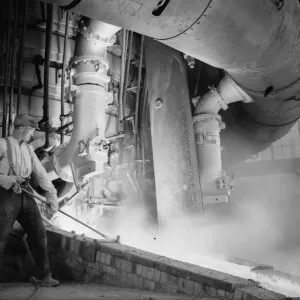 A worker checks the molten metal at the new one million pound furnace at Ford A worker checks the molten metal at the new one million pound furnace at Ford