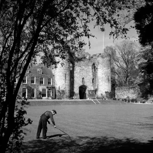 A worker cleaning the grounds outside Tonbridge Castle in Kent May 1952 A worker cleaning the grounds outside Tonbridge Castle in Kent May 1952