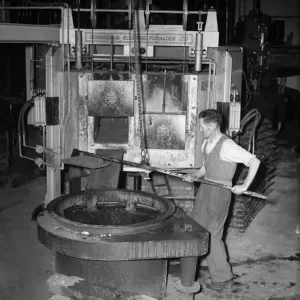 Print of a worker at K & L Steel Founders preparing a furnace
