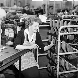 A worker at the Mansfield shoe factory in Northampton seen here trimming shoes 26th April