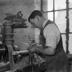 Worker operating a pottery lathe print, 1932 Worker operating a pottery lathe print, 1932