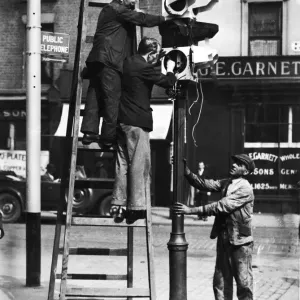 Workmen fixing one of the new ATM Traffic Controls at the junction of Islington Workmen fixing one of the new ATM Traffic Controls at the junction of Islington