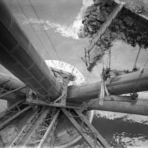 Workmen preparing a platform around one of the girders of the Forth rail Bridge prior to Workmen preparing a platform around one of the girders of the Forth rail Bridge prior to