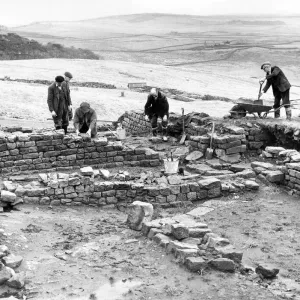 Workmen repair and tidy the remains of the Roman fort at Housesteads in Northumberland in