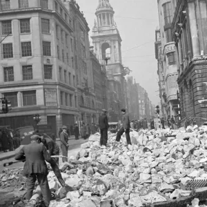 Workmen sift through the debris following the previous nights air raid on Central London