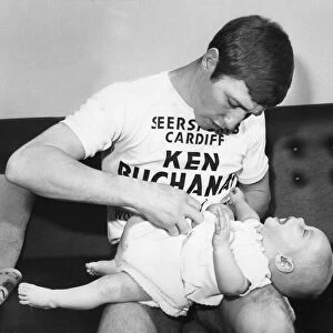 World Lightweight Champion Ken Buchanan seen here tending to his young son Mark during a